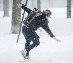  ?? DARIO AYALA / POSTMEDIA NEWS ?? We’ve all done it before. A woman loses her footing on a sidewalk through Jeanne-Mance Park in Montreal.