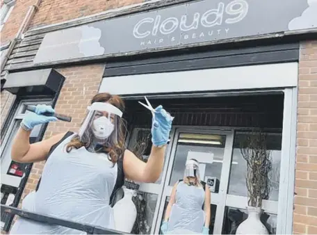  ??  ?? Cloud 9 Hair & Beauty owner Debra Ann Adamson, left, with staff member Caitlin Trotter before a client tested positive for COVID-19.