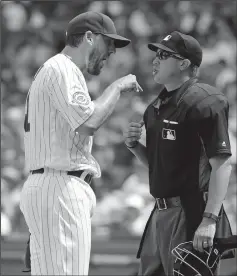  ?? BRIAN CASSELLA/TRIBUNE NEWS SERVICE ?? Chicago Cubs starting pitcher John Lackey has an argument with umpire Cory Blaser after finishing the sixth inning on July 17, 2016, at Wrigley Field in Chicago, Ill.