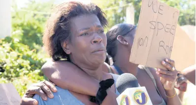  ?? PHOTOS BY ASHLEY ANGUIN/PHOTOGRAPH­ER ?? Sandra McIntosh-Bryan, mother of 11-year-old Jason Bryan, breaks down during an interview in Gutters, St James, on Tuesday. Jason died from crash injuries on Monday.