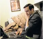  ?? Photos by Nick Otto / Special to The Chronicle ?? Daniel Kravtsov works on his computer late at night at his home in San Francisco’s Hayes Valley. Most of Kravtsov’s team is still in Russia; he has been unable to bring key developers over to the U.S. because of strict visa laws.