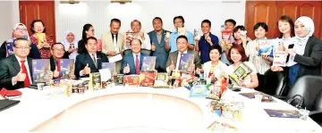  ??  ?? Tangau (seated middle) and SME owners with local products which will be showcased at the upcoming Malaysia Internatio­nal Halal Showcase.