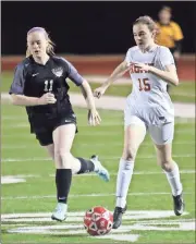  ?? Jeremy Stewart / RN-T ?? Rome High’s Mae Pierce (15) moves the ball into the box ahead of East Paulding’s Morgan Gramling during Tuesday’s Region 7-5A game at Barron Stadium.