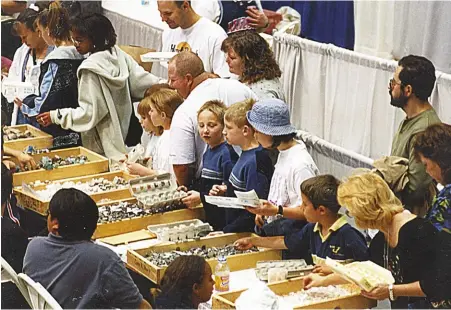  ?? BOB JONES ?? At the Tucson Gem and Mineral Show, area university students hold a mineral give-away so kids can collect their own egg carton mineral collection.