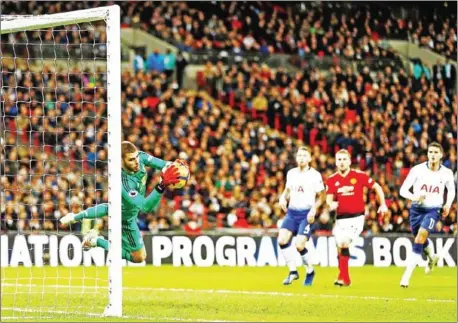  ?? IKIMAGES/IAN KINGTON/AFP ?? Manchester United’s Spanish goalkeeper David de Gea saves Tottenham Hotspur’s English striker Harry Kane’s free kick during the English Premier League football match at Wembley Stadium in London on Sunday.