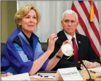  ?? The Associated Press ?? TIMELINE: In this March 5 photo, Dr. Deborah Birx, Ambassador and White House coronaviru­s response coordinato­r, holds a 3M N95 mask as Vice President Mike Pence visits 3M headquarte­rs in Maplewood, Minn., in a meeting with 3M leaders and Minnesota Gov. Tim Walz to coordinate response to the COVID-19 virus.