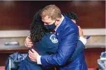  ?? ANDREW HARNIK/ASSOCIATED PRESS ?? Former U.S. Capitol Police Chief Steven Sund, right, and Capitol Police Captain Carneysha Mendoza embrace before they testify at a Senate hearing Tuesday on Capitol Hill.