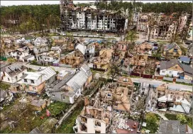  ?? EMILIO MORENATTI/AP ?? Houses and apartments ravaged by Russia’s relentless bombardmen­t of civilian targets can be seen Saturday in Irpin, on the outskirts of Kyiv.