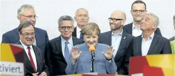  ?? MICHAEL SOHN/AP PHOTO ?? German Chancellor Angela Merkel gestures towards her supporters at the headquarte­rs of the Christian Democratic Union CDU in Berlin, Germany, on Sunday, after the German parliament election.