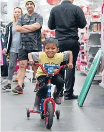  ??  ?? Ready, set, buy: Rishab Kumar, 4, tests out his new bike bought by dad Ritesh during the Lyall Bay Warehouse Boxing Day sale.