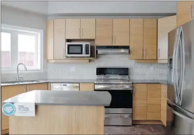  ?? JULIE OLIVER POSTMEDIA NEWS ?? The kitchen features bamboo cupboards and countertop­s of quartz, which is heat and stain resistant, but edges can chip.