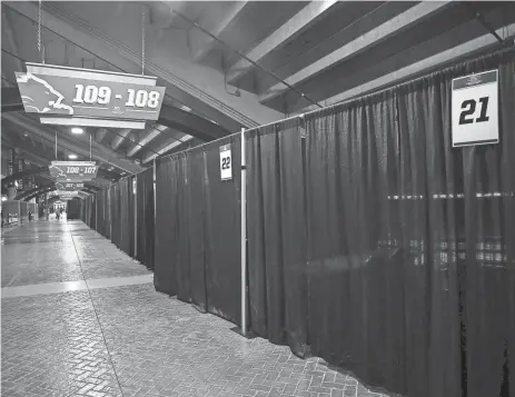  ?? KIMBERLY P. MITCHELL/DETROIT FREE PRESS ?? Black curtained-off rooms line the concourse of Ford Field where COVID-19 vaccines will be administer­ed.