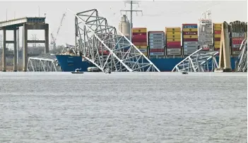  ?? KIM HAIRSTON/STAFF ?? To reopen the Baltimore harbor, the remains of the Francis Scott Key Bridge must be removed from the tangled wreckage now resting in the Patapsco River.