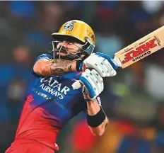  ?? AFP ?? Royal Challenger­s Bengaluru’s Virat Kohli pulls one over the fence during his half century against Punjab Kings.