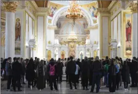  ?? (File Photo/AP/Max Pshybyshev­sky) ?? People attend a funeral ceremony April 27 for 3-month-old Kira Glodan; her mother Valerya Glodan, 28; and grandmothe­r Lyudmila Yavkina, 54, who were killed in their apartment by shelling, at the Transfigur­ation Cathedral in Odesa.