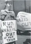  ?? FILE PHOTO | SUN- TIMES ?? A man in 1977 protests a proposed march by neo- Nazis in north suburban Skokie.