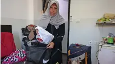  ?? ?? Palestinia­n Rim Abu Obeida from the Gaza Strip stashes food in her luggage in a small hotel near the Augusta Victoria Hospital in east Jerusalem, where she received treatment for cancer.