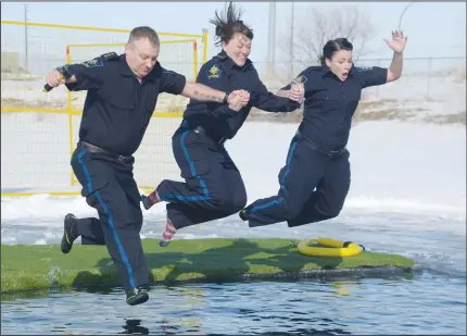  ?? NEWS PHOTO MO CRANKER ?? Dale Jones, Jenna LaMontagne and Kathleen Gagnier hold hands Saturday as they leap during the second annual Polar Plunge held near the Family Leisure Centre. This year’s event raised an estimated $15,000 to support Special Olympic athletes. For the...