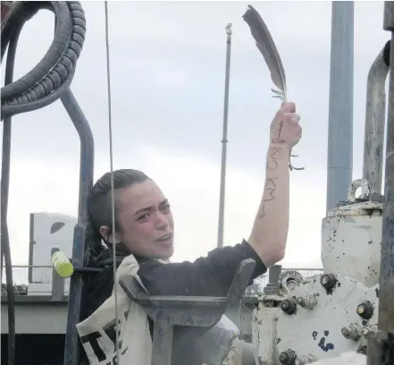  ?? — LAUREL DYKSTRA ?? Ezra Green protests the Trans Mountain Pipeline expansion at a work site near Highway 1 and Brunette Avenue on Thursday. She was arrested by police and taken into custody.