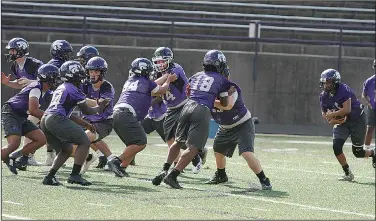  ?? Terrance Armstard/News-Times ?? Working it out: El Dorado's football team works out during spring practice at Memorial Stadium. The Wildcats will put on full pads on Monday with an 8 a.m. practice scheduled for the high school.