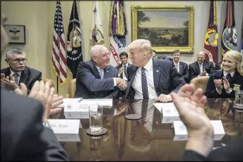  ?? ANDREW HARNIK / AP ?? “I know it’s a little bit overcast outside,” said new Agricultur­e Secretary Sonny Perdue, shown here shaking hands with President Donald Trump, “but I can assure you: it’s Sonny on top of those clouds.”