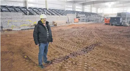  ?? JASON SIMMONDS • THE GUARDIAN ?? Cedric Gallant, project manager for the Tyne Valley Events Centre, stands on the ice surface with the seating area behind him. Gallant, who will also assume the manager’s role for the 2021-22 season, said the goal is for the multi-purpose facility to have ice and be open in early October. The events centre will replace the Tyne Valley and Area Community Sports Centre, which was destroyed by fire on Dec. 29, 2019.