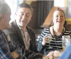  ??  ?? Kathleen Smith of Bethlehem has a good laugh as her husband, Phil, center, strikes up a conversati­on with Don Boyle of Hanover Township while hanging out Monday at McCarthy’s Red Stag Pub & Whiskey Bar in Bethlehem.