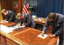  ?? JEFF AMY / ASSOCIATED PRESS ?? Zinus USA President Ha Bong Sung (from left), Gov. Brian Kemp and Henry County Developmen­t Authority Chairman Pierre Clements sign the agreement Tuesday at the state Capitol. The company will set up its first U.S. factory in McDonough.