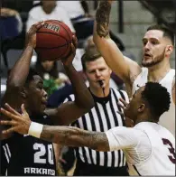  ?? Arkansas Democrat-Gazette/MITCHELL PE MASILUN ?? Central Arkansas guard Matthew Mondesir (left) looks to pass out of a double team set by UALR’s Rayjon Tucker (3) and Nikola Maric during the Bears’ 85-82 victory over the Trojans on Saturday at the Jack Stephens Center.
