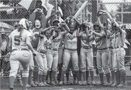  ?? STAFF PHOTOS BY DOUG STRICKLAND ?? The Ooltewah softball team waits at home for teammate Mabry Carpenter (5) after her three-run homer during the Lady Owls’ TSSAA Class AAA state softball game against Gibbs on Wednesday in Murfreesbo­ro, Tenn.