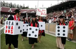  ??  ?? Graduating Stanford students arrive dressed as dice during the traditiona­l “Wacky Walk” to the school’s commenceme­nt ceremony.