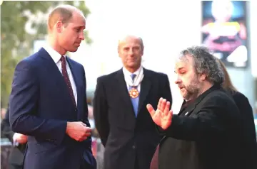  ??  ?? Britain’s Prince William, Duke of Cambridge speaks with New Zealand film maker Peter Jackson as he attends the world premiere of Peter Jackson’s film “They Shall Not Grow Old” during the BFI London Film Festival in London, Britain Oct 16 • (above right) Jackson arrives for the world premiere of his film and Prince William speaks with Diane Lees, director-general of Imperial War Museums and commission­ers and producers of “14-18 Now” as he attends the world premiere. — Reuters photos