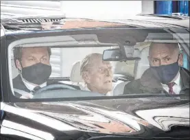  ?? The Associated Press ?? Britain’s Prince Philip, center, on Tuesday leaves King Edward VII’S Hospital in London. The 99-year-old husband of Queen Elizabeth II had been hospitaliz­ed since Feb. 16.