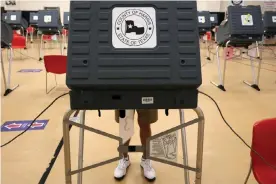  ?? Photograph: Aaron M Sprecher/EPA ?? A voter casts their ballot at an early voting polling location for the presidenti­al election in Houston, Texas, on 15 October 2020.