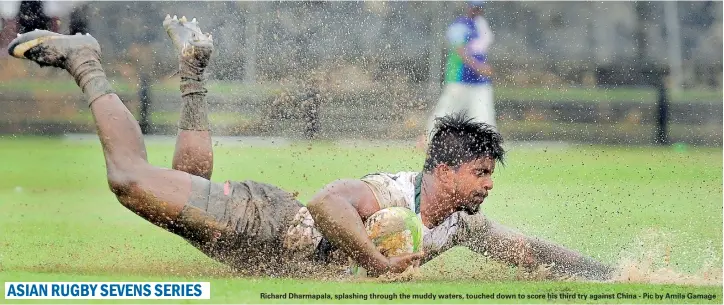  ??  ?? Richard Dharmapala, splashing through the muddy waters, touched down to score his third try against China - Pic by Amila Gamage