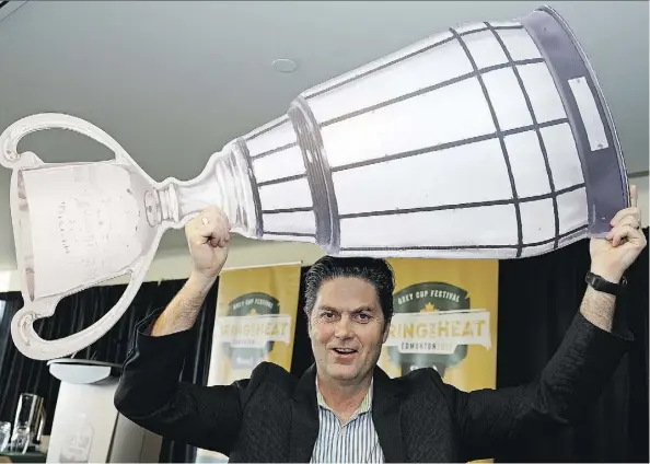  ?? LARRY WONG ?? Duane Vienneau, executive director of the 2018 Grey Cup festival, hoists a mock Grey Cup in promoting the 106th edition scheduled for Commonweal­th Stadium on Nov. 25. Tickets will be made available to the public Friday, with expectatio­ns of selling out...