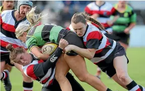  ?? ROBYN EDIE/STUFF ?? Marist halfback Brooke Churstain is well wrapped up by Sariah Tautari, left, and Lydia McRae of Midlands.