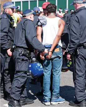  ??  ?? Handcuffed: One of the 300 arrests at this weekend’s event