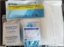  ?? U.S. IMMIGRATIO­N AND CUSTOMS ENFORCEMEN­T — THE ASSOCIATED PRESS ?? Unapproved COVID-19tests that were seized on March 22 from the DHL Express Consignmen­t Facility at JFK Airport in New York City.