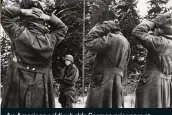  ??  ?? An American soldier holds German prisoners at gunpoint during the battle of the Bulge, 1944