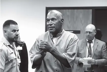  ?? FILE PHOTO BY JASON BEAN/THE RENO GAZETTE-JOURNAL VIA AP ?? O.J. Simpson reacts on July 20 after learning he was granted parole at Lovelock Correction­al Center in Lovelock, Nev.