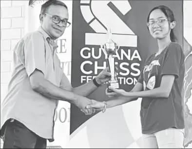  ?? ?? Maliha Rajkumar receives her trophy and certificat­e following her National U-16 Girls championsh­ip triumph