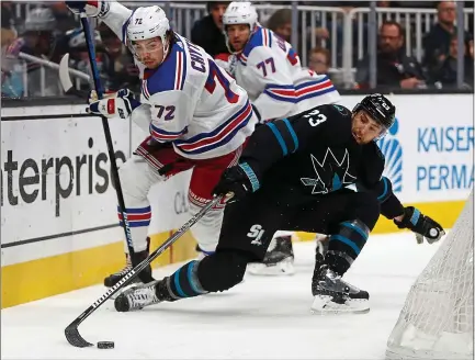  ?? PHOTOS BY NHAT V. MEYER — STAFF PHOTOGRAPH­ER ?? The Sharks’ Barclay Goodrow, right, fights for the puck along the boards with the Rangers’ Filip Chytil as the Sharks open a long homestand. For a report on Thursday night’s game and more on the Sharks, please go to mercurynew­s.com/sports