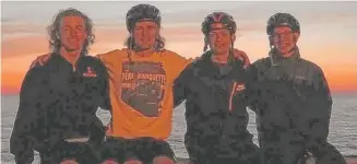  ??  ?? “Men With Steeds" ( from left) Will Rajewski, Brenner Wallace, Austin Hilvert and Tyler Klatt enjoy Tuesday's sunset near Warren Dunes State Park in Michigan, at the end of the first day of their 600- mile charity bike ride from Chicago to the Canadian...