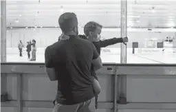  ?? PHOTOS BY SEAN LOGAN/THE REPUBLIC ?? Left: Jeremy Accardo holds up Locke Accardo, 5, on Thursday at Coyotes Community Ice Center in Mesa.