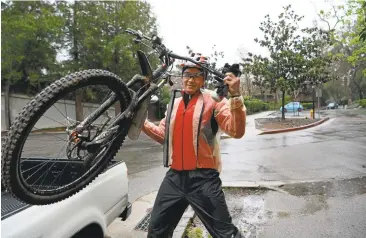  ?? DAN HONDA/STAFF ?? Despite a light, but steady rain, Jose Sinang, of Campbell, prepares to ride along a part of the Los Gatos Trail in Los Gatos on Friday morning. Gusty winds and drenching rains are excepted to return late Sunday and Monday, weather officials say.