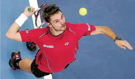  ??  ?? All eyes: Second seed Stanislas Wawrinka of Switzerlan­d going for a smash against Marcos Baghdatis of Cyprus in the second round of the Malaysian Open last night. Wawrinka won 6-1, 7-5. — S.S. KANESAN / The Star