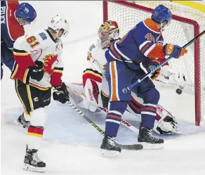  ?? DAVID BLOOM ?? Oilers winger Tyler Pitlick, left, scores on Calgary Flames goaltender Jon Gillies during pre-season action at Rogers Place on Monday.