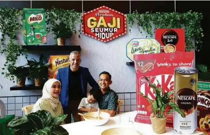  ?? ?? Nestle (Malaysia) Bhd chief executive officer Juan Aranols (standing) with ‘Salary for Life’ 2020 grand prize winner Amirrul Hafiz Razak and his family recently.