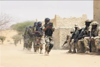  ?? Jerome Delay / Associated Press 2015 ?? Nigerian and Chadian troops participat­ed with U.S. advisers in 2015 in Chad. U.S. and French forces have provided training to the militaries in the Sahel region bordering the Sahara Desert.